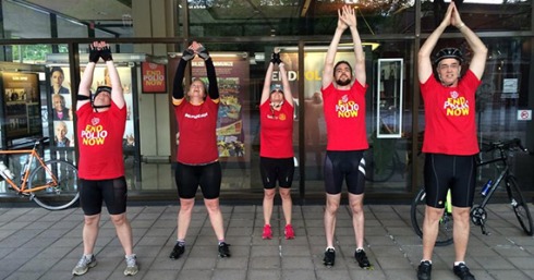 Adam Arents, second from right, leads the Miles to End polio team in a yoga stretch.